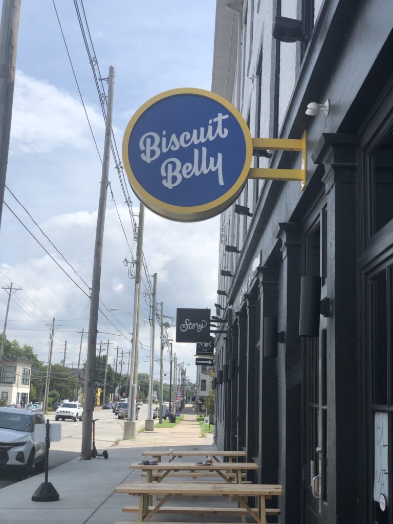 Outdoor sign for Biscuit Belly restaurant in Louisville, KY